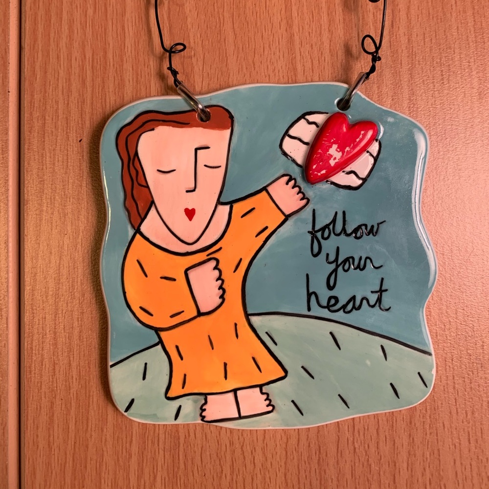 Hanging tile message. “Follow your heart”